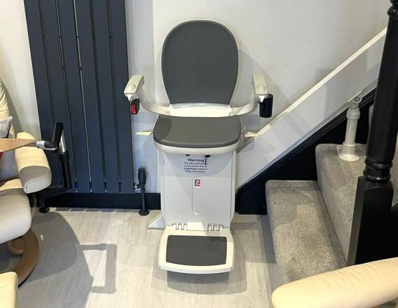 Acorn 180 Curved Stair lift with grey upholstery