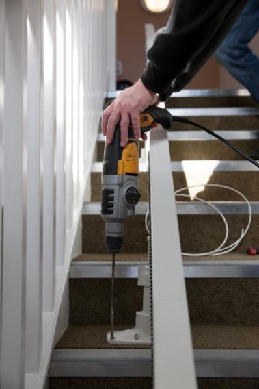 Stairlifts are fixed to the stairs not the wall